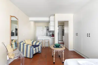 a living room with a couch and a table at Sea Spray A410 in Cape Town