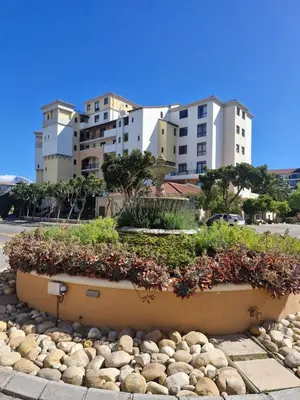 a large planter with flowers in front of some buildings at Island Club apartment in Century City - 305 Ibiza in Cape Town