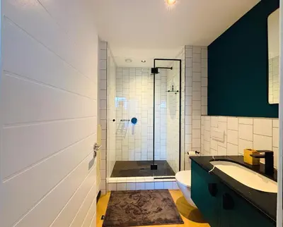 a bathroom with a shower with a toilet and a sink at ZALS Luxury Accommodation-One bed-Cape Town in Cape Town