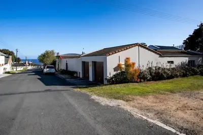 a house on the side of a road at Plaisir du Cap in Hermanus