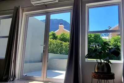 a room with a sliding glass door with a plant at C'est la Vie 3 in Franschhoek