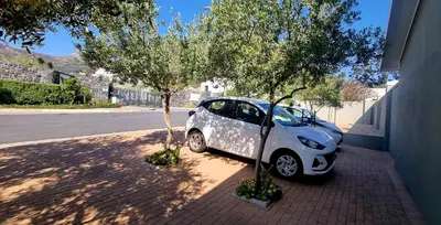 a small white car parked next to a tree at C'est la Vie 3 in Franschhoek