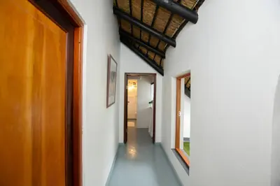 a hallway with white walls and a wooden door at Mountain View and Vineyard View in Suider-Paarl