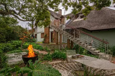 a fire pit in a yard in front of a house at Mountain View and Vineyard View in Suider-Paarl