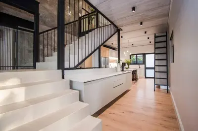 a staircase in a house with white walls and wooden floors at Modern House Dalsig Stellenbosch in Stellenbosch