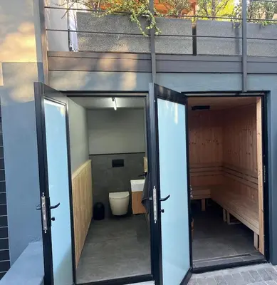 a bathroom with two doors and a toilet at Modern House Dalsig Stellenbosch in Stellenbosch