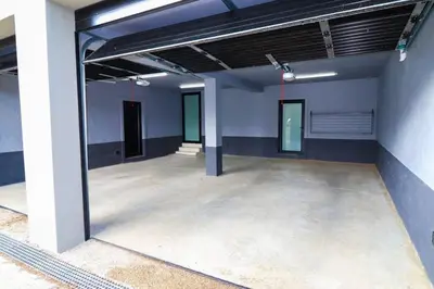 a large empty room with blue walls and concrete floors at Modern House Dalsig Stellenbosch in Stellenbosch