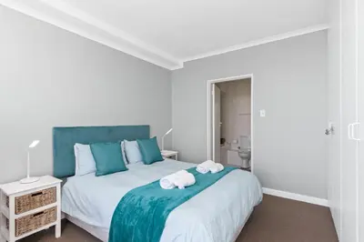 a bedroom with two towels on a bed at Odeon Towers 1102 in Cape Town