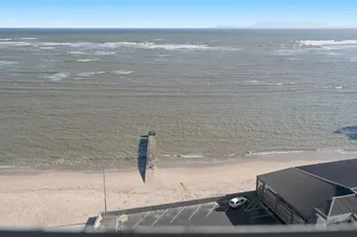 a view of a beach with a blue flag at Odeon Towers 1102 in Cape Town