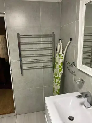 a bathroom with a shower and a sink at KBJ House in Cape Town