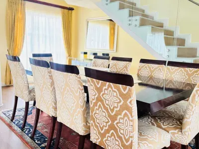 a dining room with a glass table and chairs at KBJ House in Cape Town