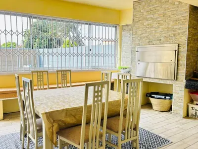 a kitchen with a table and chairs and a large window at KBJ House in Cape Town