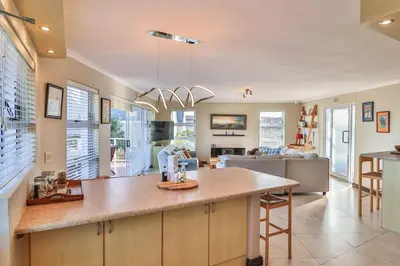 a kitchen with a large island in a room at Mocha Bay House by the Sea in Bettyʼs Bay