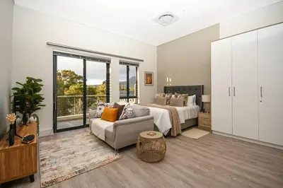 a large bedroom with a bed and a couch at 308 on Titanium in Strand