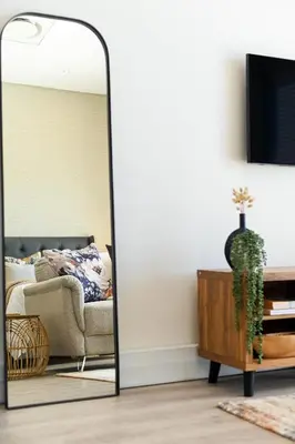 a mirror in a living room with a couch at 308 on Titanium in Strand
