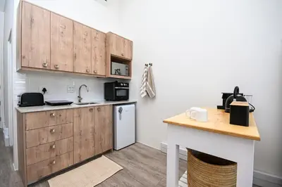a kitchen with wooden cabinets and a white refrigerator at 308 on Titanium in Strand