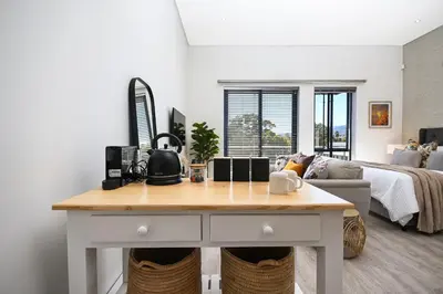 a living room with a table in front of a bed at 308 on Titanium in Strand