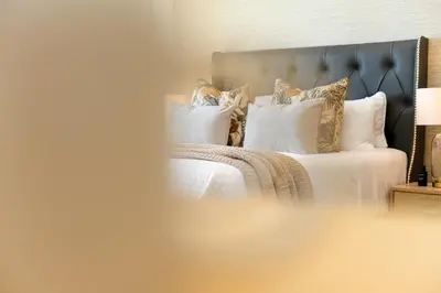 a bedroom with a bed with white sheets and pillows at 308 on Titanium in Strand
