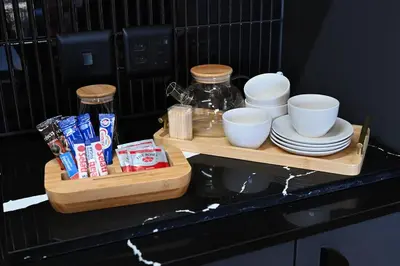 a shelf with plates and cups and bowls on a counter at BGS Luxury -Two-bed -Nine Palms in Cape Town