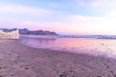 a sandy beach with a view of the ocean at Soete Rus Strand in Cape Town