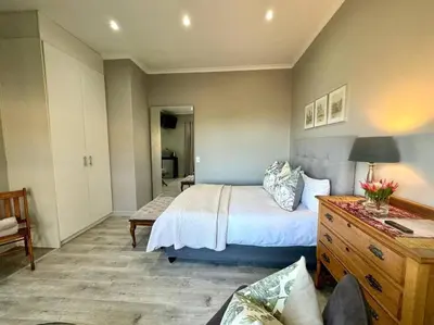 a bedroom with a bed and a wooden dresser at Room With A View in Windsor Park