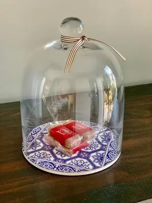 a glass cloche with a plate of food on a table at Room With A View in Windsor Park