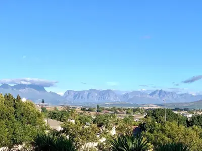 a view of a city with mountains in the distance at Room With A View in Windsor Park