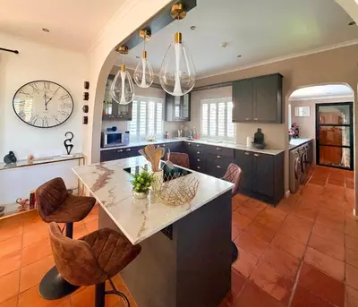 a kitchen with a large island with a counter top at Franschhoek Three Bedroom Cottage On Dirkie Uys in Franschhoek