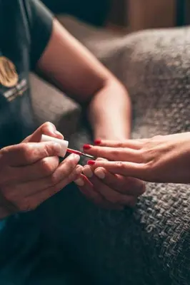 a person sitting on a couch holding a pair of scissors at C'est la Vie 1 in Franschhoek
