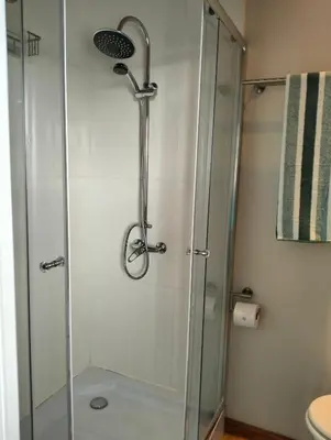 a shower with a glass door in a bathroom at C es Cape in Pringle Bay