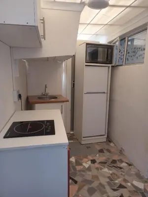 a small kitchen with a stove and a sink at One Bedroom Apartment in Cape Town