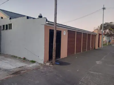 an empty parking lot next to a building at One Bedroom Apartment in Cape Town