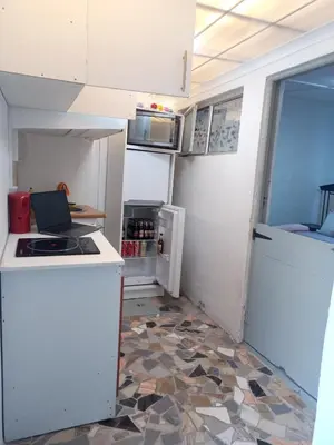a small kitchen with a stove and a refrigerator at One Bedroom Apartment in Cape Town