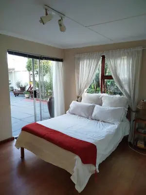 a bedroom with a large white bed with white pillows at Mountain View Apartment in Cape Town