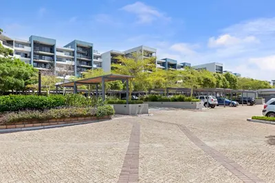 a parking lot in front of a building at Two Bedroom Luxury Apartment, Century City - BackUp Power in Cape Town