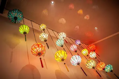 a bunch of colorful umbrellas hanging from a ceiling at The Glass Castle Retreat in Sir Lowry Pass