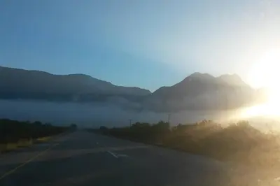 an empty road with mountains in the background at Heaven's Door in Bettyʼs Bay