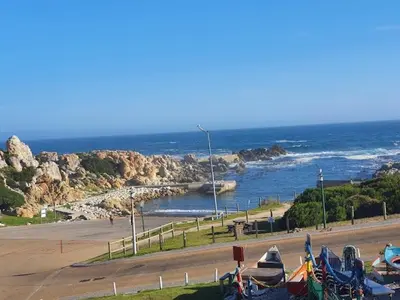 a group of tents on a beach near the ocean at Shekinah at Sea in Kleinmond