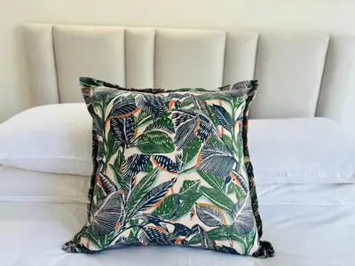 a pillow sitting on top of a bed at Hermanus Garden Studios in Hermanus