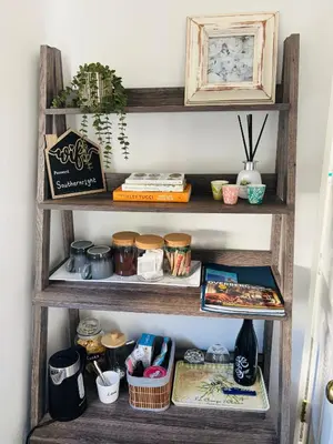 a wooden shelf with food items on it at Hermanus Garden Studios in Hermanus