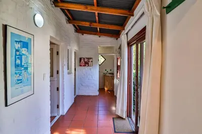 a hallway of a house with a tile floor at Hilbre House in Bettyʼs Bay