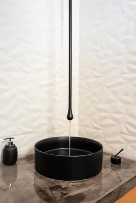 a black bowl with a shower on a table at The Glass Castle in Sir Lowry Pass