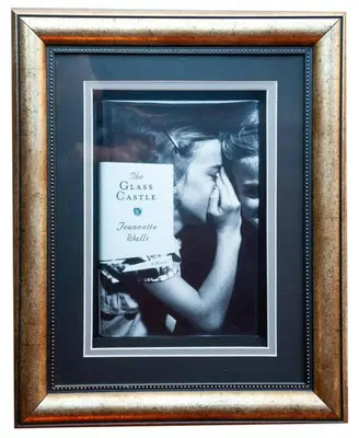 a framed picture of a woman holding a book at Golden Sunset Room in Sir Lowry Pass