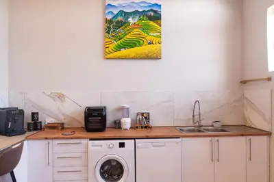 a kitchen with a sink and a washing machine at Serenity Vista Retreat in Cape Town