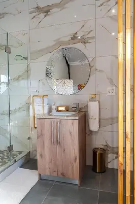 a bathroom with a sink and a mirror at Serenity Vista Retreat in Cape Town