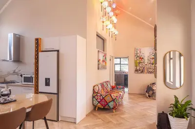 a kitchen and dining room with a table and a chair at Serenity Vista Retreat in Cape Town