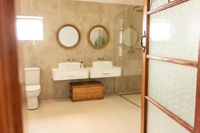 a bathroom with two sinks and two mirrors at The View Guesthouse & Cottage in Caledon