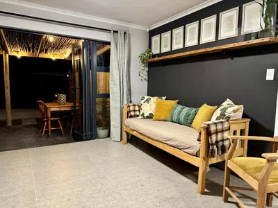 a living room with a couch and a table at Stones - Cape Town Self Catering in Cape Town