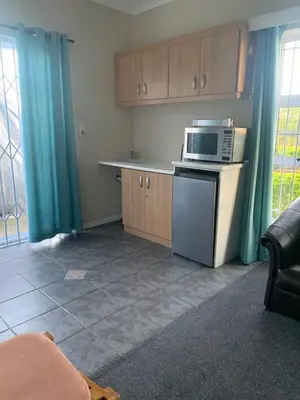 a kitchen with a stove and a microwave at Table Mountain Views in Cape Town