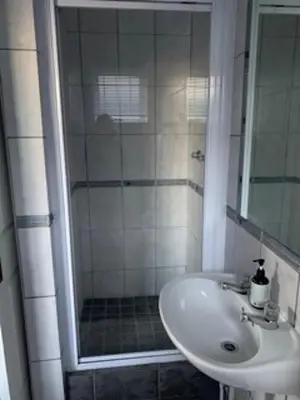 a bathroom with a sink and a shower at Table Mountain Views in Cape Town